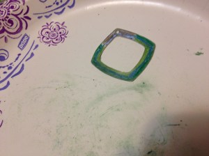 To eliminate the harsh edges of the colored pencil, wad up a paper towel and rub the colors vigorously. They will blend and smooth nicely. After this is done, using an agate burnisher, burnish the parts that have not been colored (if any). Spray with the fixative that artists generally use on colored pencil. Be sure to hold your breath while spraying -- that stuff is vile!